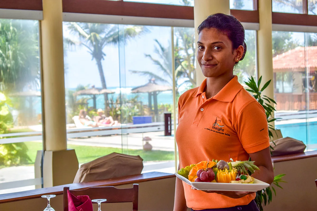 Insight Resort steward serving fruit